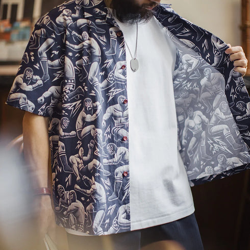 Person wearing a patterned shirt over a white t-shirt with a blurred background